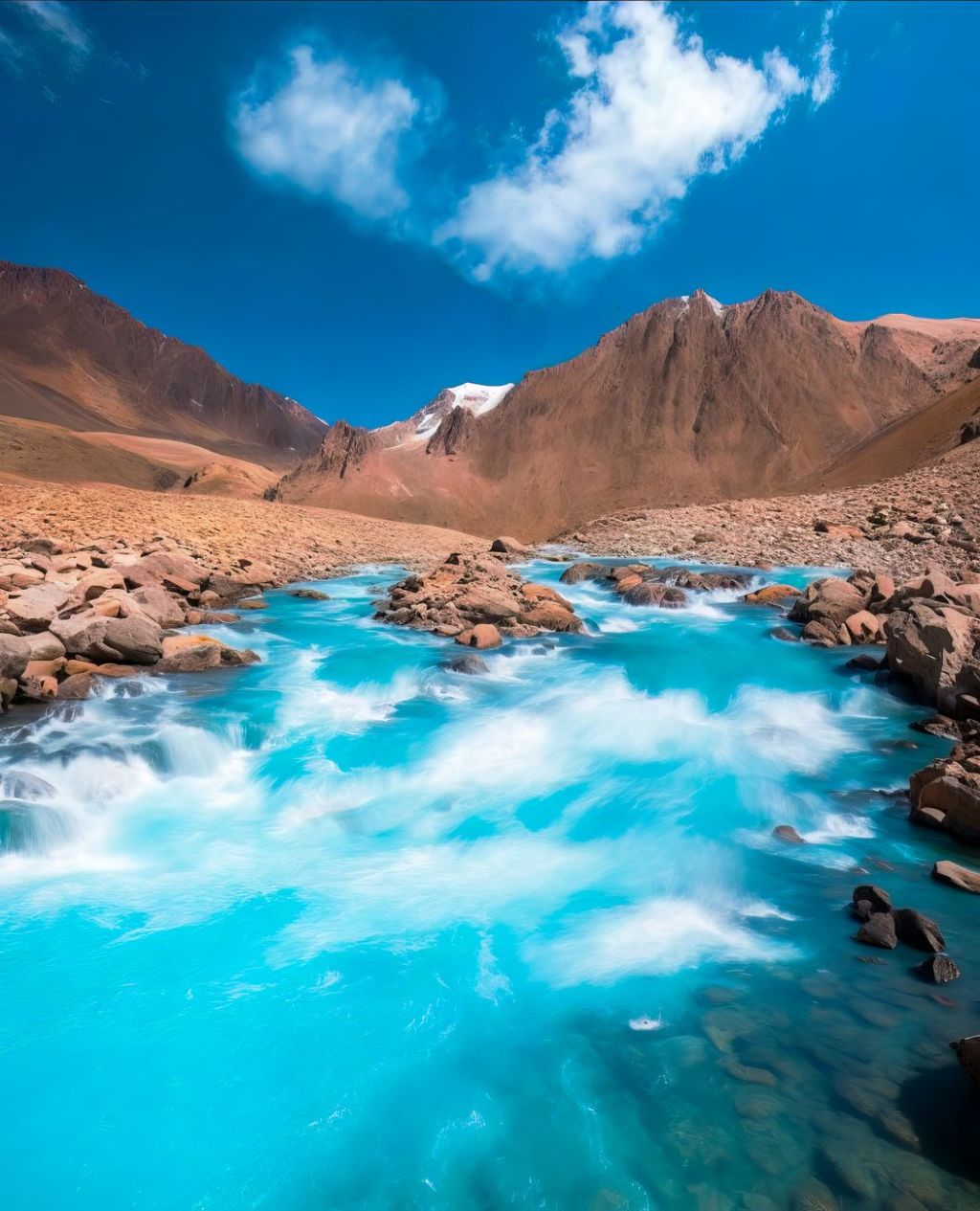 scenic view of clear stream in the middle of desert mountains